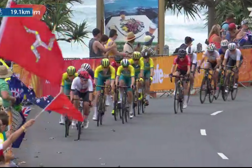 Manx Flags waved on TV as the Peloton comes along Currumbin Beachfront